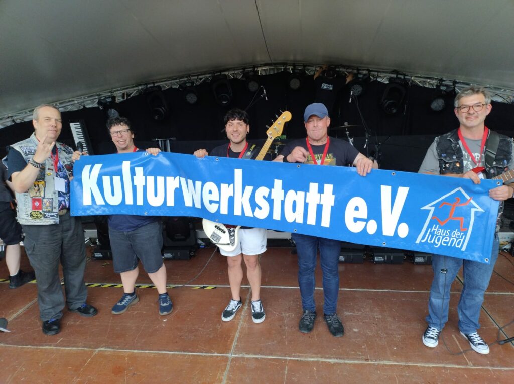 menschen, die ein Banner der Kulturwerkstatt halten